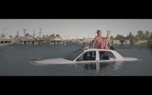 Beyoncé on a police car that is submerged in water